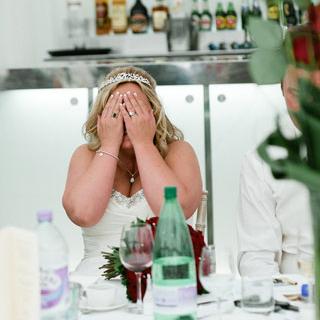 Bride covering face with hands